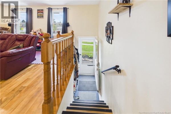 Interior view of the staircase and hallway leading to the backyard entrance. - 84 Glencoe Drive, Moncton