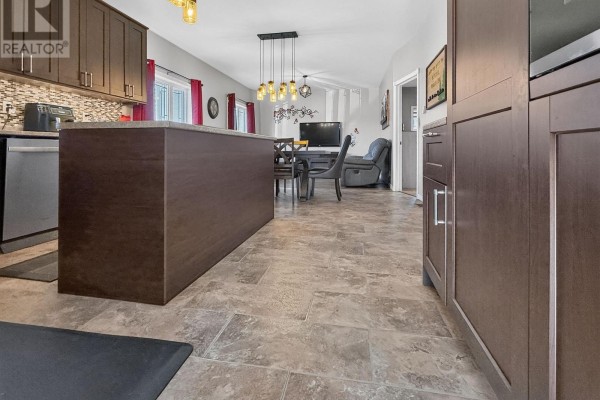 Kitchen with island, dining table, and recliner - 84 Highway 11 Highway E Hearst