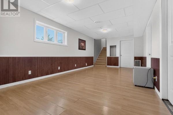 Finished basement with wood paneling, drop ceiling, and wood floors - 84 Highway 11 Highway E Hearst