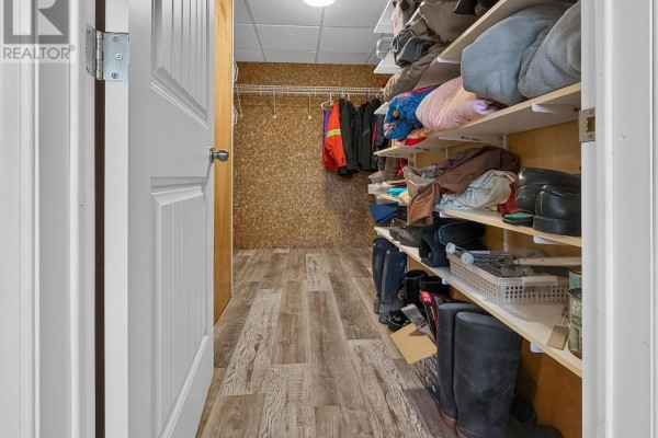 Hallway with shelves, clothes, boots, and vinyl plank flooring - 84 Highway 11 Highway E Hearst