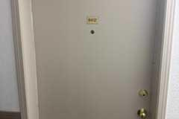 Apartment entrance door with gold knob and number 402. - 8412, 304 Mackenzie Way Sw, Airdrie