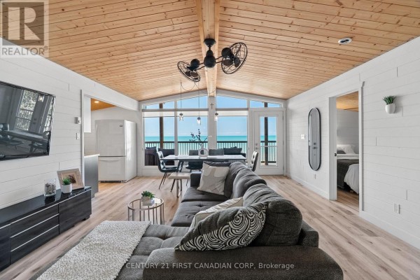 Small kitchen with dark wood cabinets, stainless steel appliances, and a window view. - 84153 Lakeland Estates Road, Ashfield Colborne Wawanosh