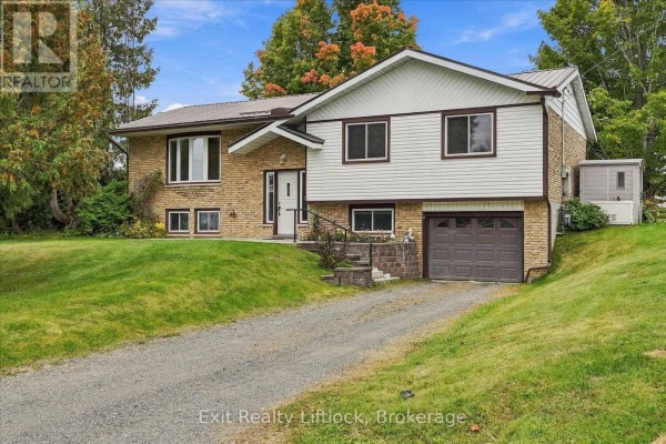 Front view of a split-level house with brick and vinyl siding. - 842 Chemongview Drive, Selwyn
