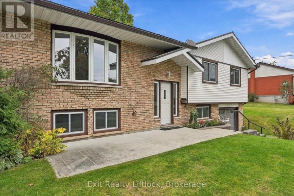 Close-up of the front entrance and brick facade of a split-level home. - 842 Chemongview Drive, Selwyn