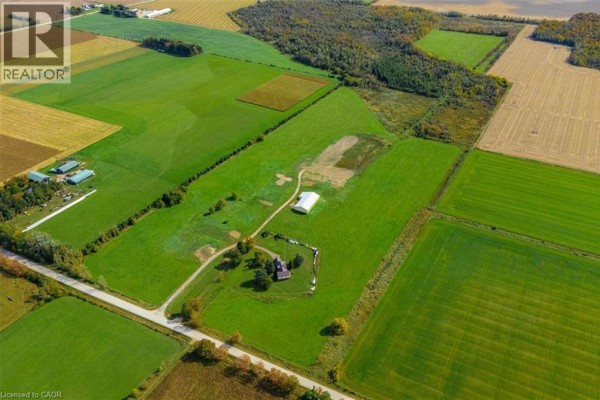 Aerial view of a property with multiple agricultural buildings, fields, and surrounding farmland. - 8449 Line 2, Arthur