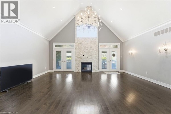 Exterior of modern home with stone facade, arched entryway, and double garage - 85 Hillcroft Drive Stoney Creek
