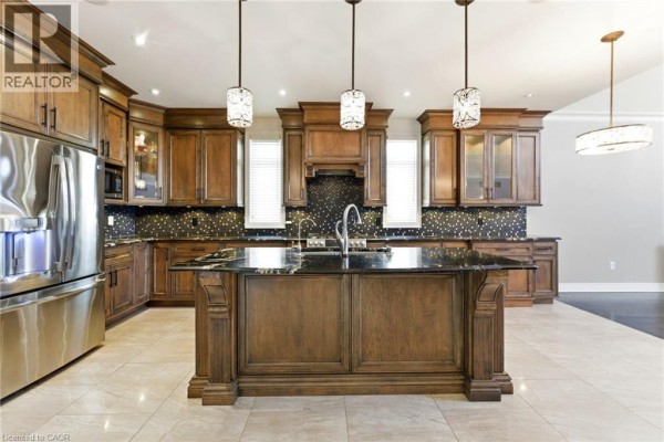 Modern double front doors with glass, stone and brick facade, and outdoor lighting - 85 Hillcroft Drive Stoney Creek