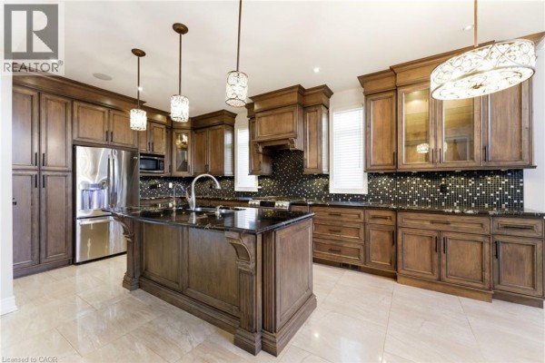 Hallway with double glass doors, chandelier, artwork, and console table - 85 Hillcroft Drive Stoney Creek