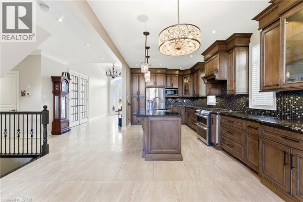 Spacious room with dark hardwood floors, window, and cabinet - 85 Hillcroft Drive Stoney Creek