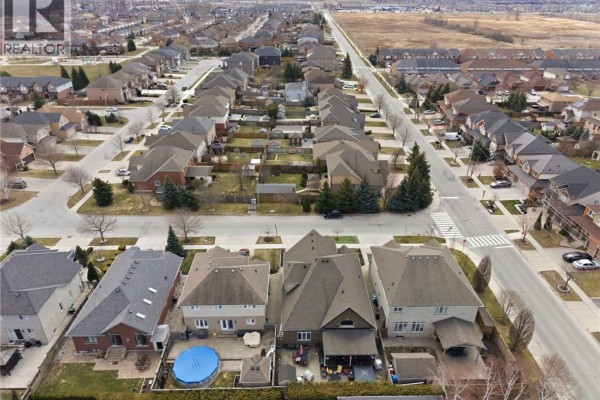 Aerial view of a residential property with a grey shingled roof, backyard pool and surrounding houses. - 85 Hillcroft Drive, Stoney Creek
