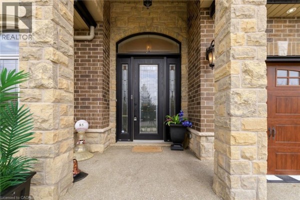 Grand foyer with crystal chandelier, staircase, fireplace & art - 85 Hillcroft Drive Stoney Creek