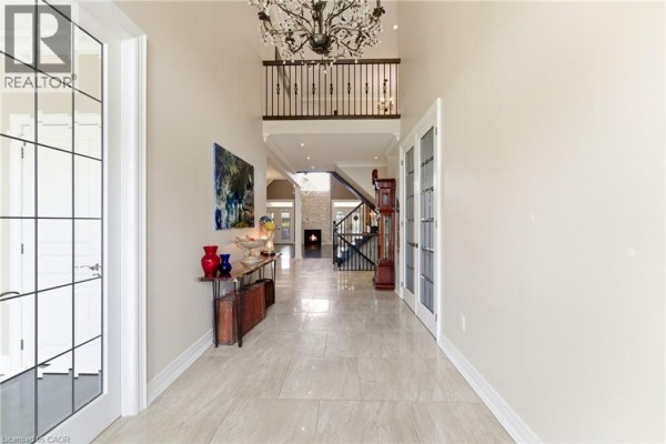 Kitchen with dark granite island, custom wood cabinets, and mosaic tile backsplash - 85 Hillcroft Drive Stoney Creek