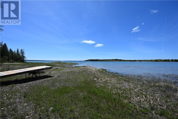 View of a tranquil lake with islands and treed shoreline under a partly cloudy sky. - 85 Leason Bay Trail, Assiginack