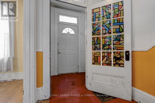 Interior view showing a white door with stained glass and an open doorway. - 85 Richmond Road, Ottawa