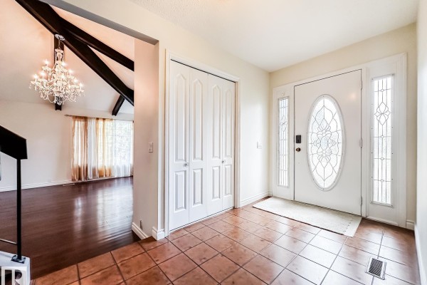Interior entryway with tan tile floor, white double doors, and a glass front door. - 8504 173 St Nw, Edmonton