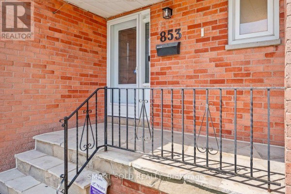 Front entrance with brick exterior, stone steps, and metal railings. - 853 Apple Gate Court, Mississauga