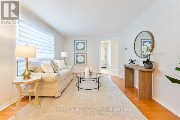 Living room with a sofa, side table, console table, and view towards entryway. - 853 Apple Gate Court, Mississauga