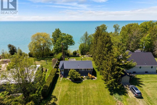 Aerial view of a grey house with a metal roof and surrounding greenery. - 85377 Mcdonald Lane, Ashfield Colborne Wawanosh