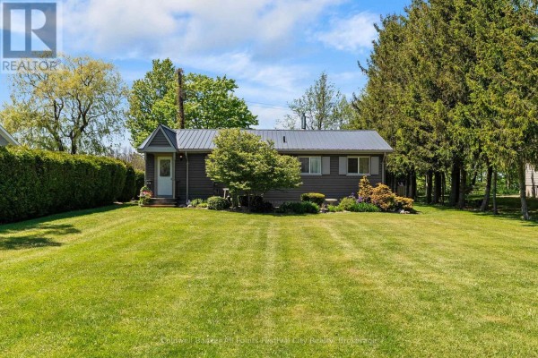 Aerial view of a grey house on a grassy lot with a large body of water in the background. - 85377 Mcdonald Lane, Ashfield Colborne Wawanosh