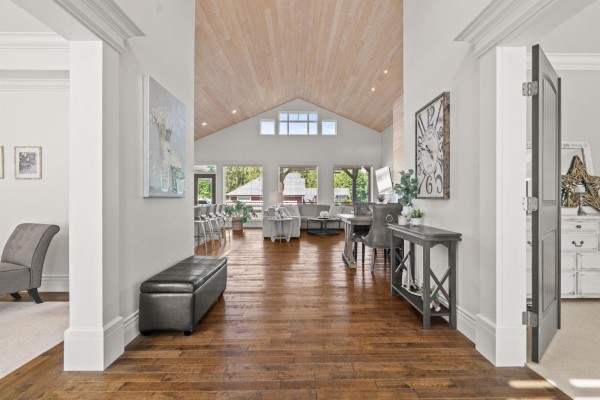 Home office with a white desk, two monitors, grey ergonomic chair, and a large window with blinds. - 8557 Fripp Terrace, Mission