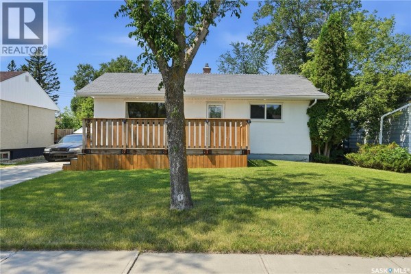View from the wooden deck looking out towards the street and neighboring houses. - 856 Forget Street, Regina