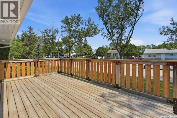 Interior entryway with beige walls, carpeted floor, white door with glass panels. - 856 Forget Street, Regina