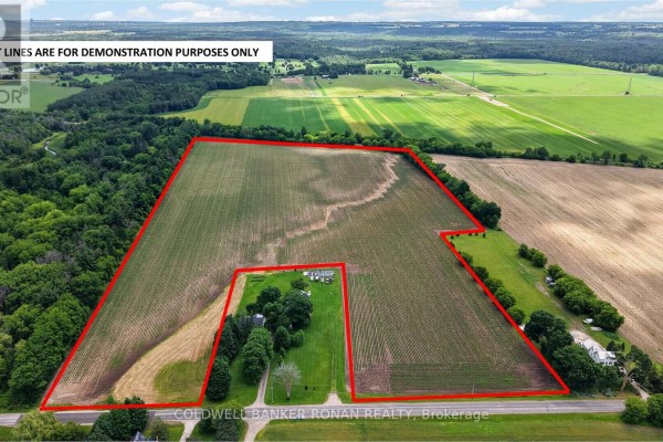 Aerial view of a farm property with red lot lines, surrounded by fields and trees. - 8562/8587 6th Line, Essa