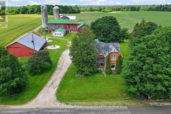 Overhead aerial view of farm buildings including green barns and silos. - 8562/8587 6th Line, Essa