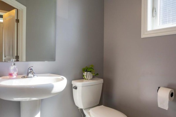 Modern bathroom with pedestal sink and toilet - 857 Cologne Street Russell