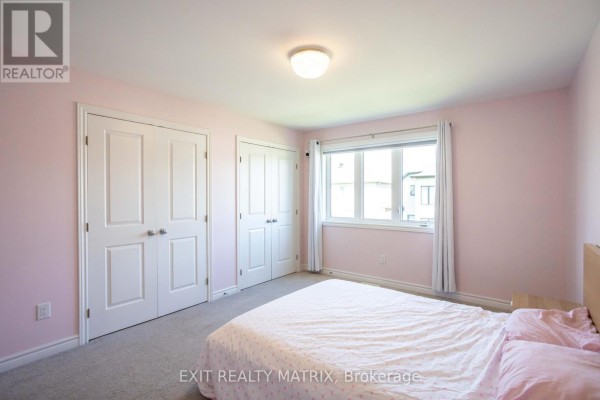 Bedroom with double closet doors and a large window - 857 Cologne Street Russell