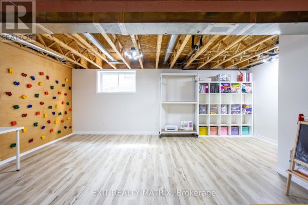 Finished basement with climbing wall, shelving, sewing machine, printer - 857 Cologne Street Russell