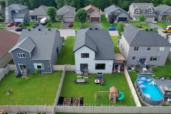 Backyard with pool, deck, playset, and seating - 857 Cologne Street Russell