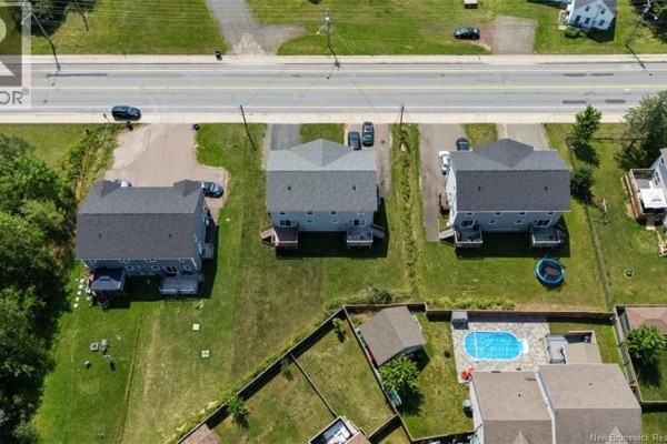 Aerial view showing residential street with multiple townhouses and houses. - 859 Ryan Street, Moncton