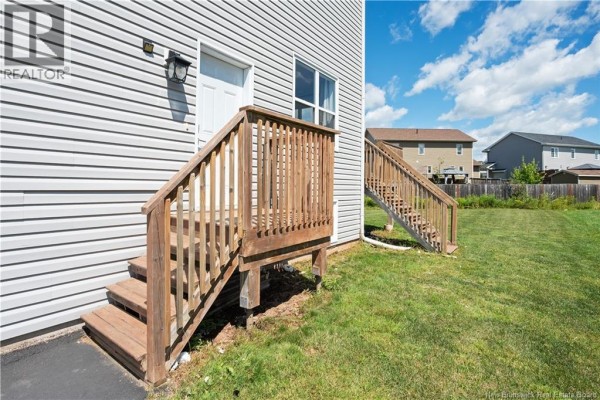 Aerial view of townhouses with paved driveways and surrounding yards. - 859 Ryan Street, Moncton