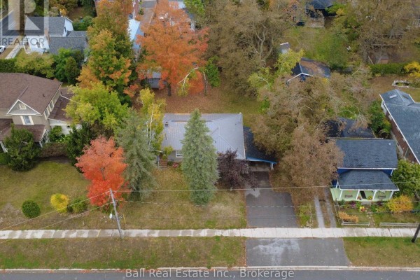 Aerial view of the bungalow and its property, showing surrounding houses and colourful trees. - 86 Albert Street, Selwyn