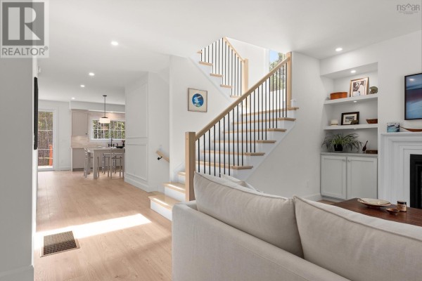 Open layout showing the living area, staircase, and dining space with natural light. - 86 Double Lane, Oakfield