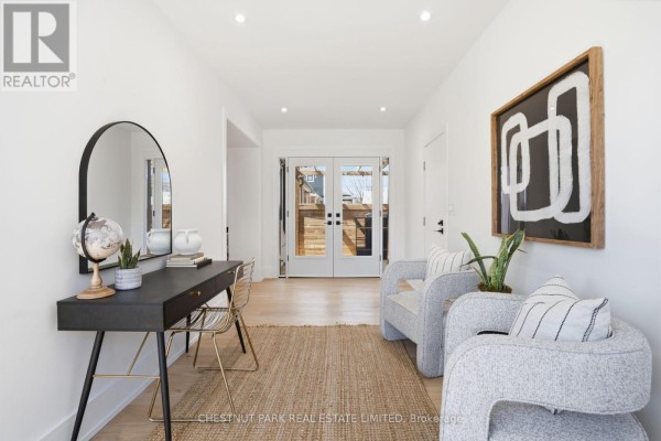 Hallway with console table, mirror, accent chairs, and double doors - 86 Edgecroft Road Toronto