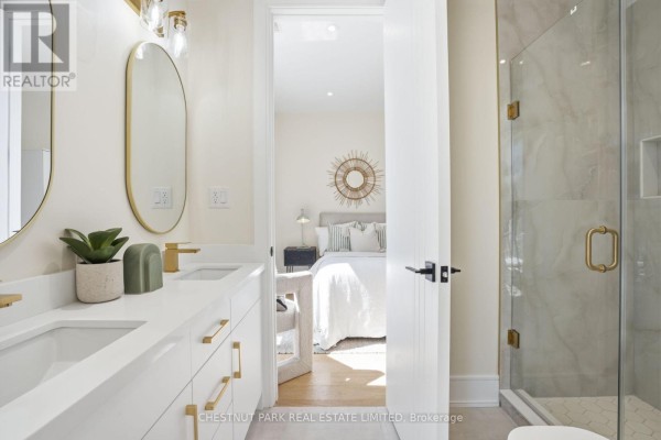Modern hallway with black front door, marble tile, hardwood floors, sofa - 86 Edgecroft Road Toronto