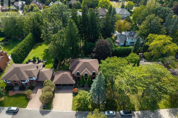Aerial view of a residential street with large homes surrounded by mature trees. - 86 Tobin Court, London South