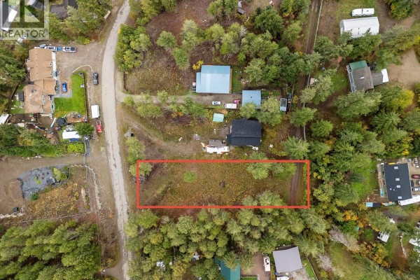 Aerial view showing two houses and cleared land surrounded by dense evergreen forest. - 861 Balsam Road, Fintry