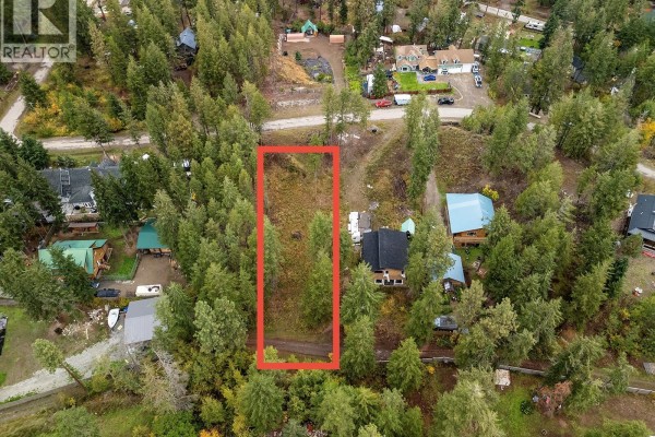 Overhead view of a treed lot with two houses, one with a blue roof, and a dirt road. - 861 Balsam Road, Fintry