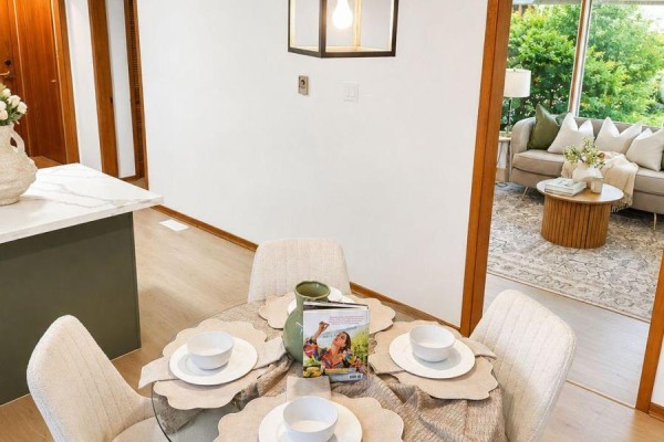 Hallway with wooden stairs, kitchen access, and closet doors. - 865 Regent Drive, Oshawa