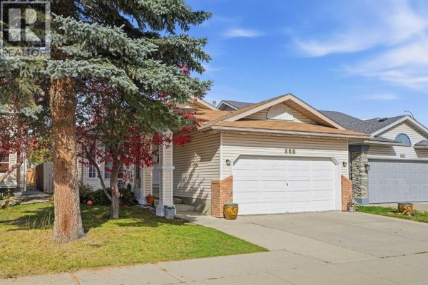 Home office with wood floors, desk with computer, sewing machine, and chairs. - 866 Applewood Drive Se, Calgary