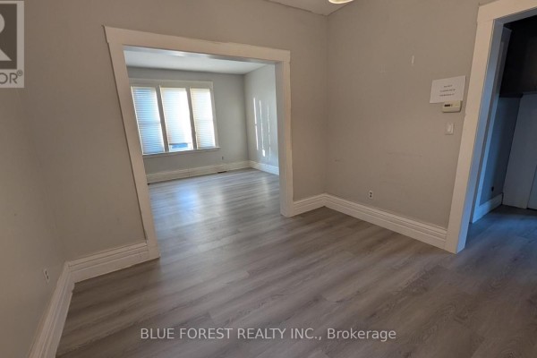 Interior doorway leading from living room to a separate room with grey flooring. - 867 Queens Avenue, London East