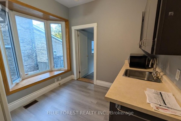 Kitchen with bay window, sink, and cabinets - 867 Queens Avenue London East