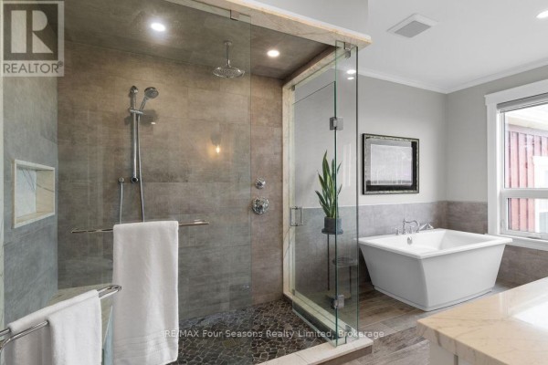 Modern bathroom with freestanding tub and glass shower - 8672 County Rd 91 Road Clearview