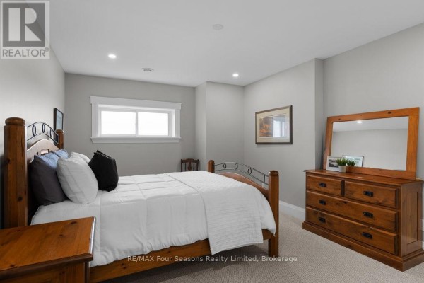 Bedroom with wooden bed and dresser - 8672 County Rd 91 Road Clearview