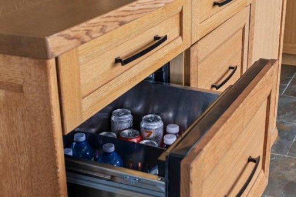 Wooden kitchen island with beverage fridge and drawers, marble backsplash, stone tile flooring - 8672 County Rd 91 Road Clearview