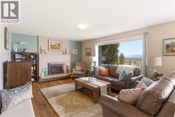 Aerial view of the house showing the driveway, garage, and front yard. - 869 Mckenzie Road, Kelowna