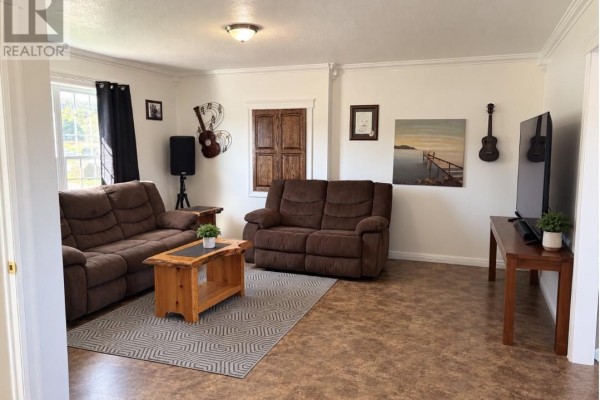 Living room with two brown reclining sofas, a rustic wooden coffee table, and a television on a wooden stand. - 86a Main Road, Piccadilly
